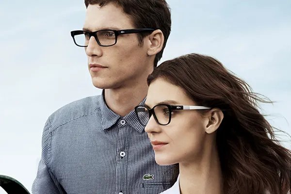 A man and a woman wearing dark designer eyeglasses
